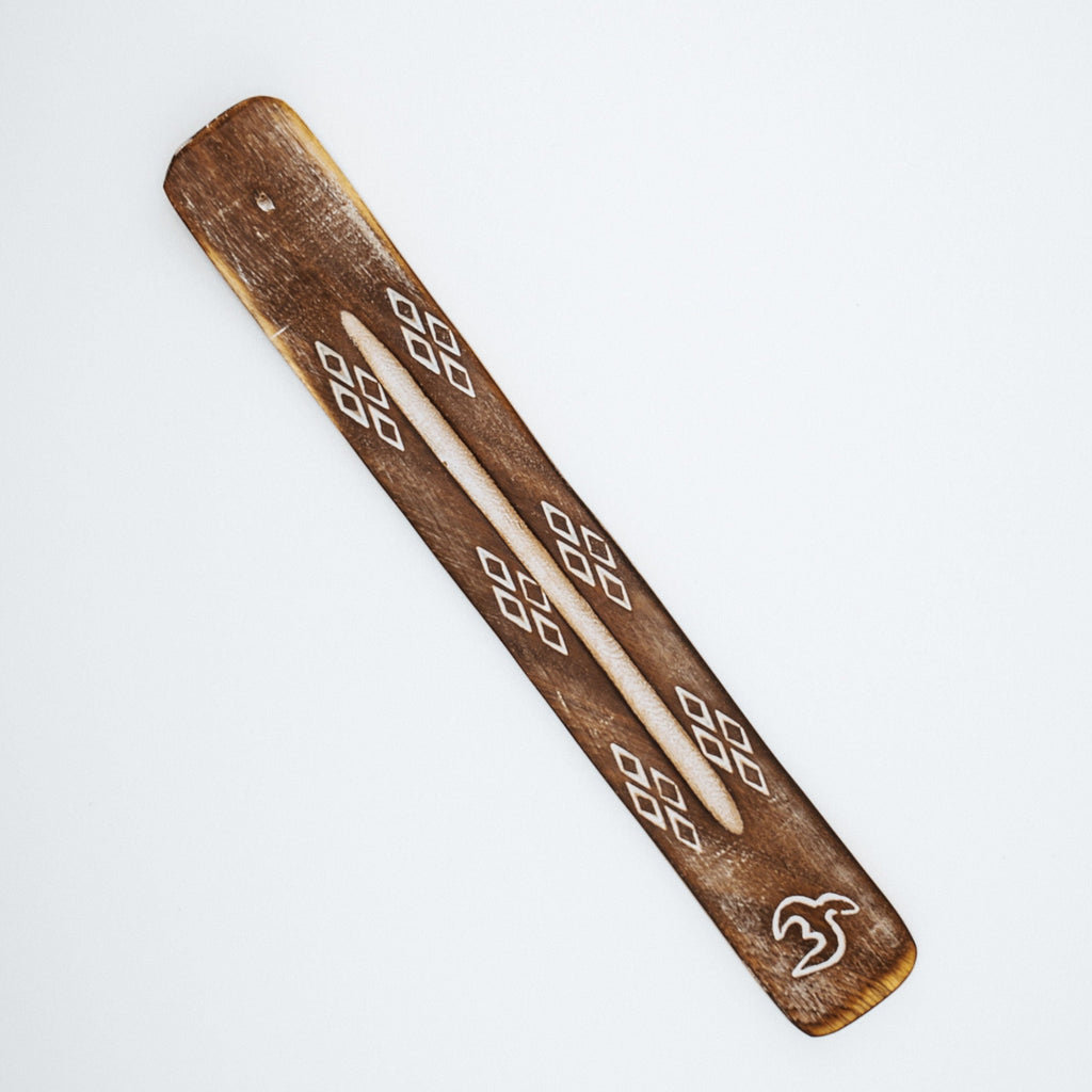 Wooden piece with geometric patterns on a white background