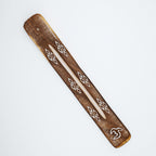 Wooden piece with geometric patterns on a white background