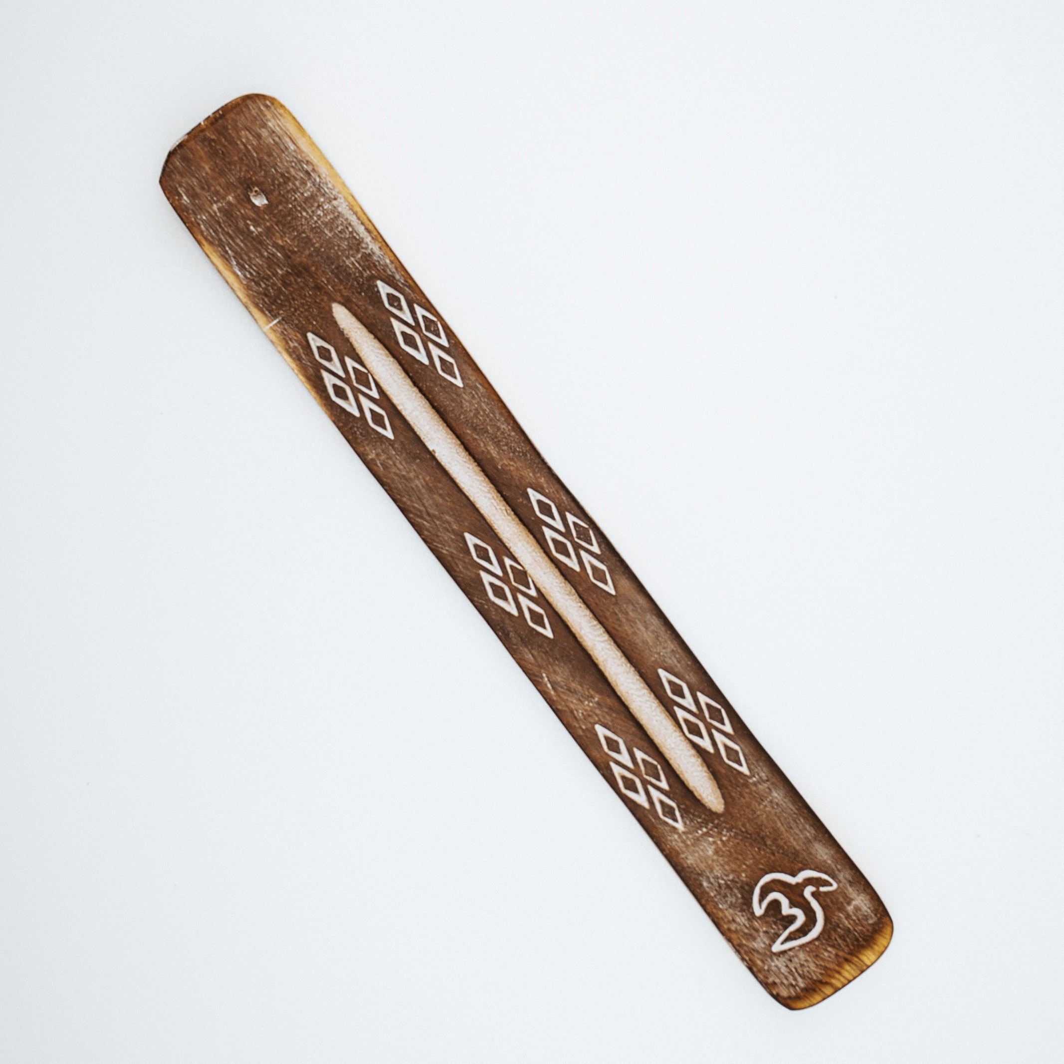Wooden piece with geometric patterns on a white background