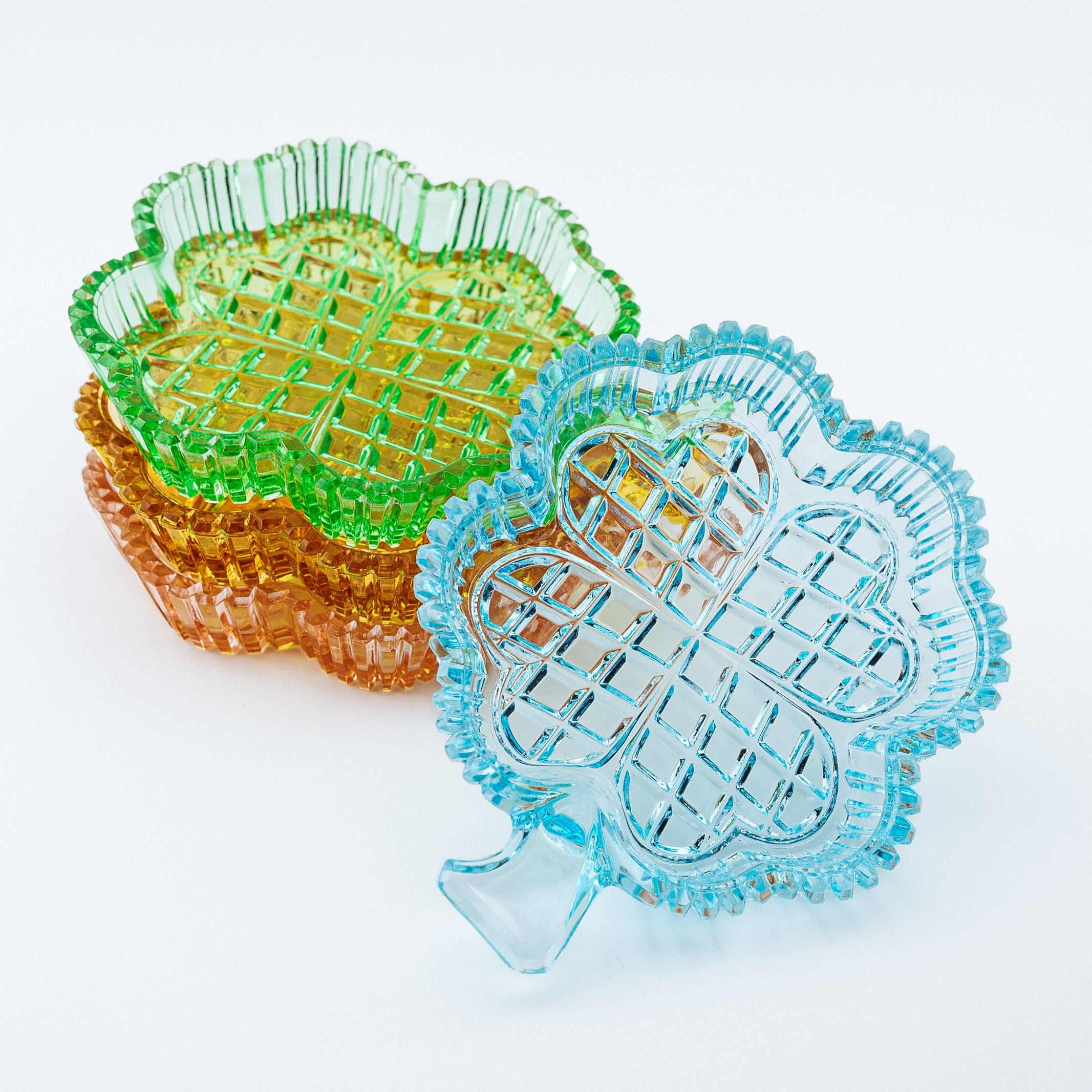 Colorful clover shaped dishes on a white background
