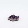 Amethyst crystal cluster on a white background