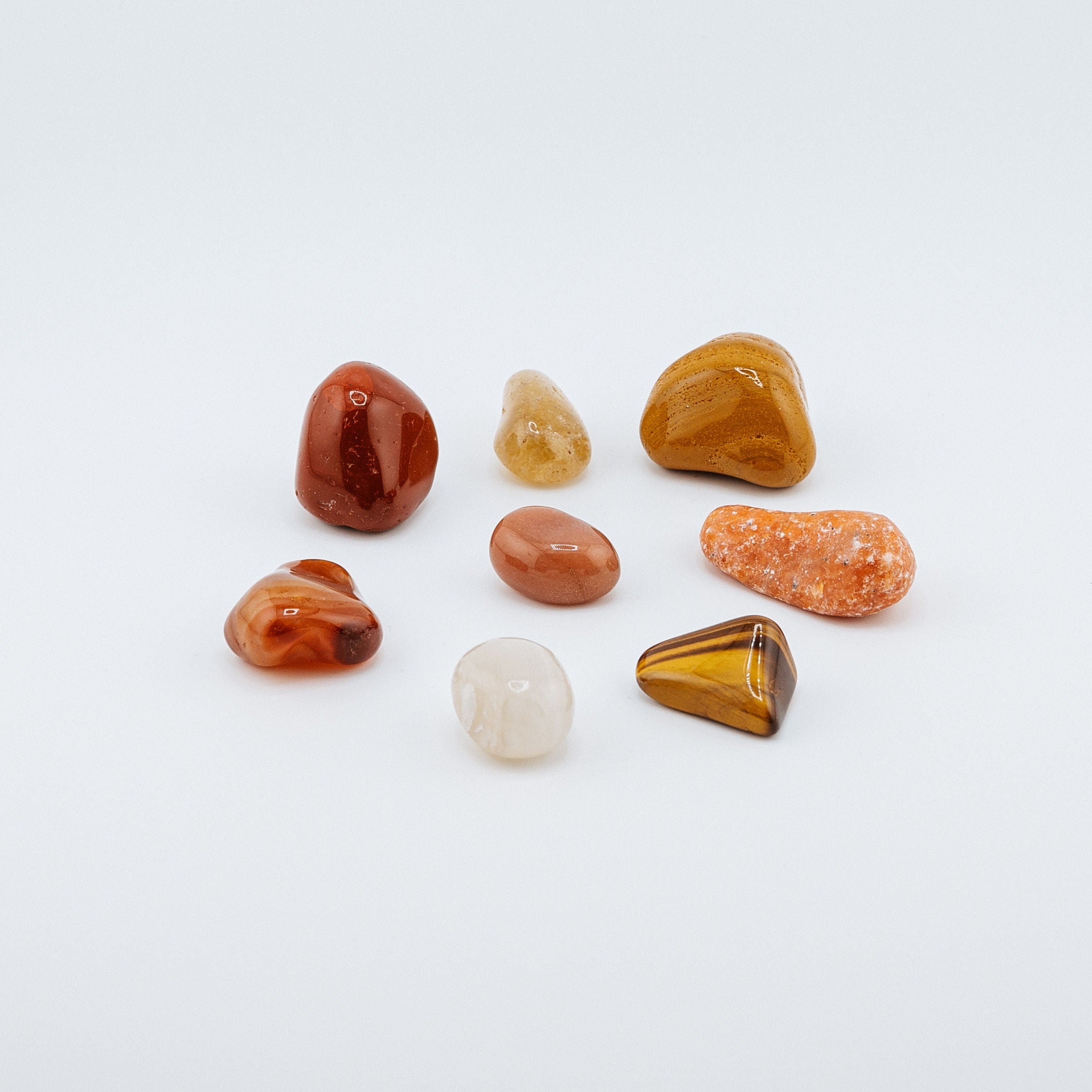 Collection of various colored stones on a white background