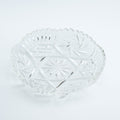 Clear glass bowl with decorative pattern on a white background