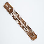 Wood piece with elephant design on a white background