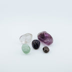 Five different colored gemstones on a white background
