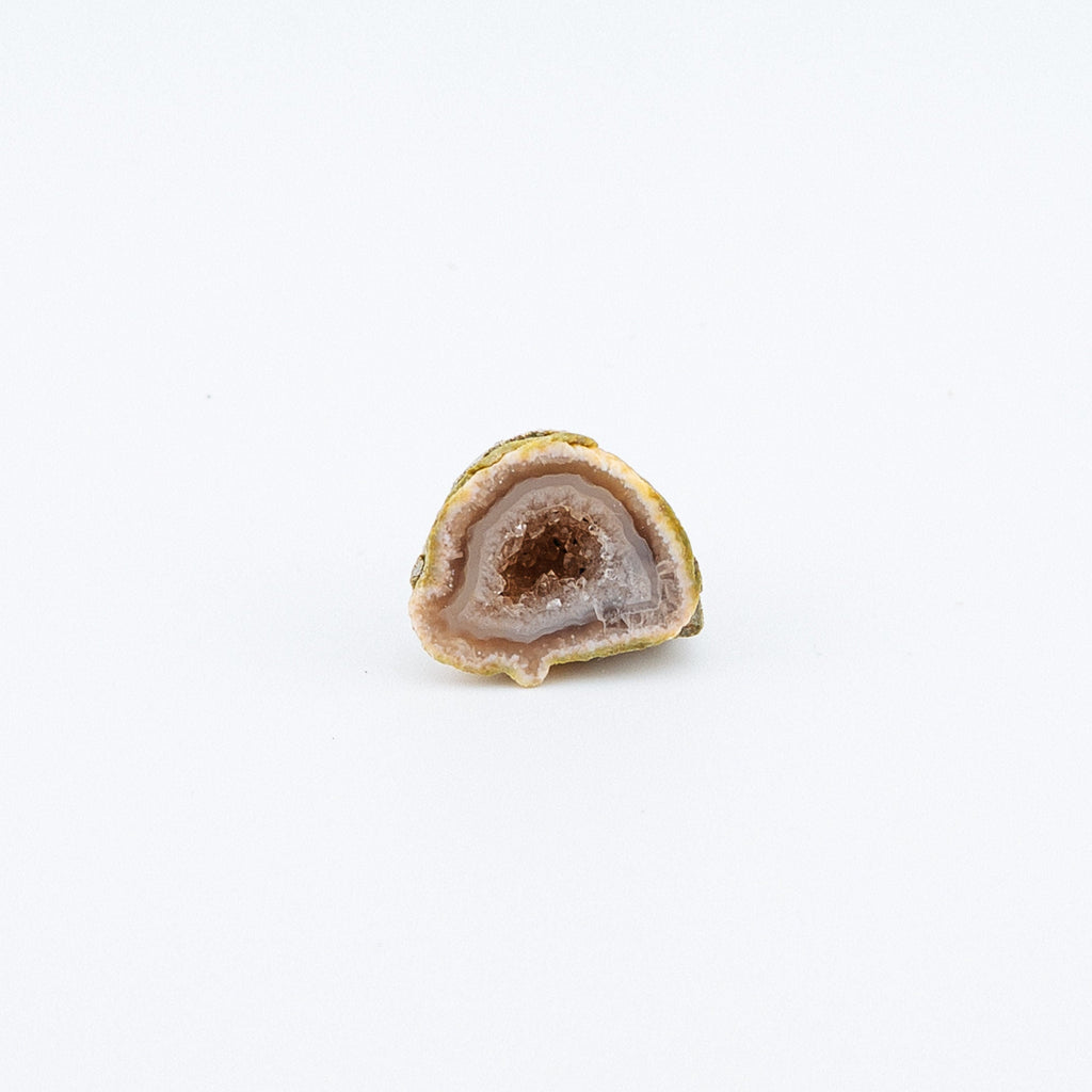 Geode cut in half on a white background