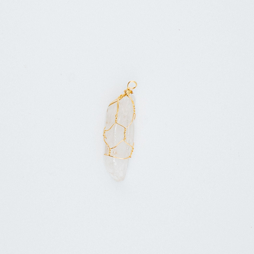 Gold clear pendant on a light gray background