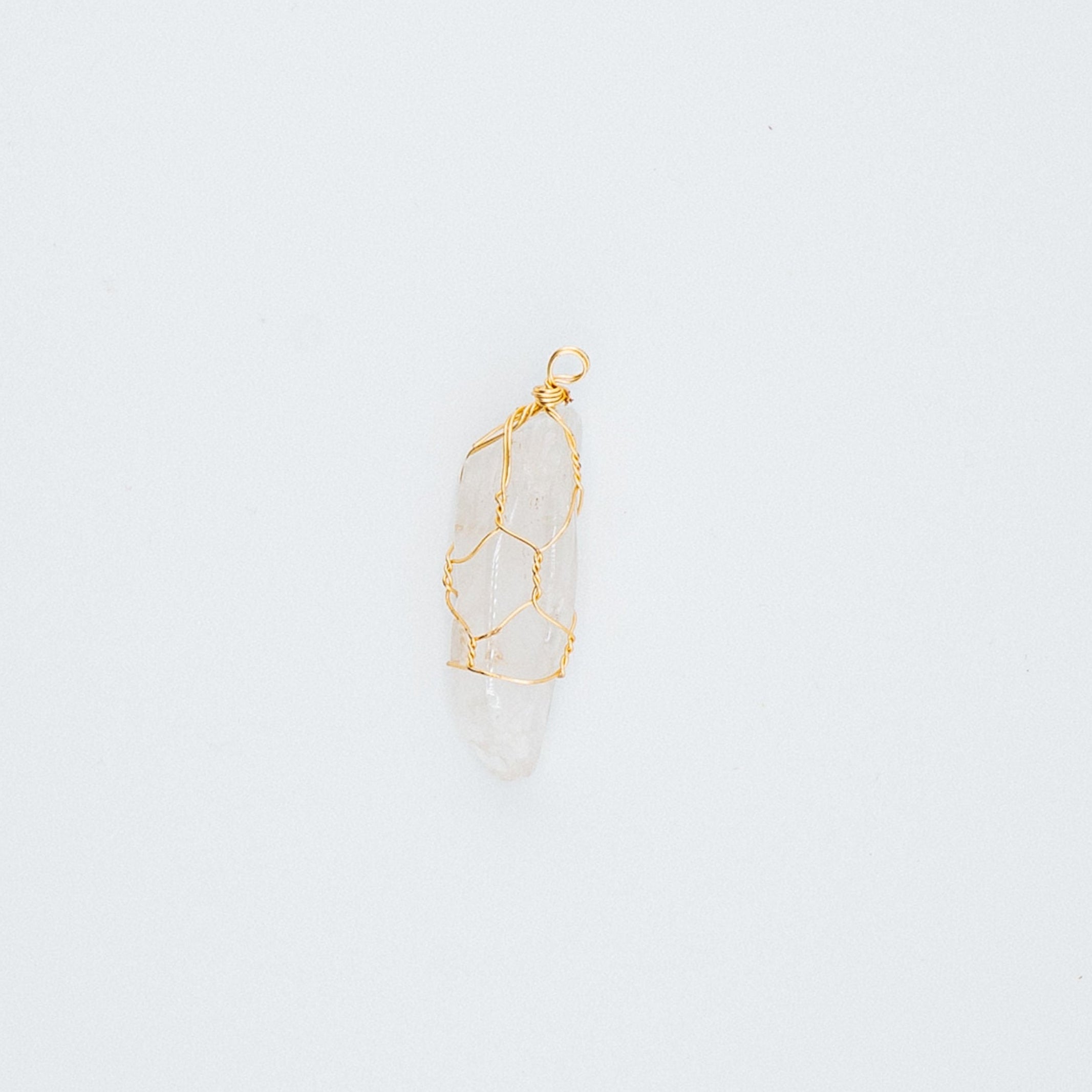 Gold clear pendant on a light gray background