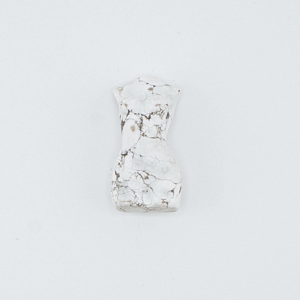 Small white carving on a light gray background
