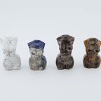 Four small stone sculptures on a white background