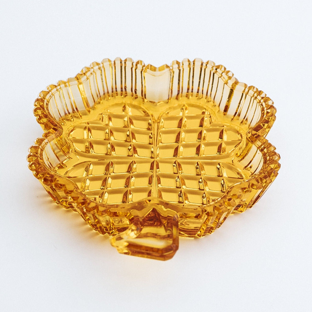 Orange glass dish with textured surface on a white background
