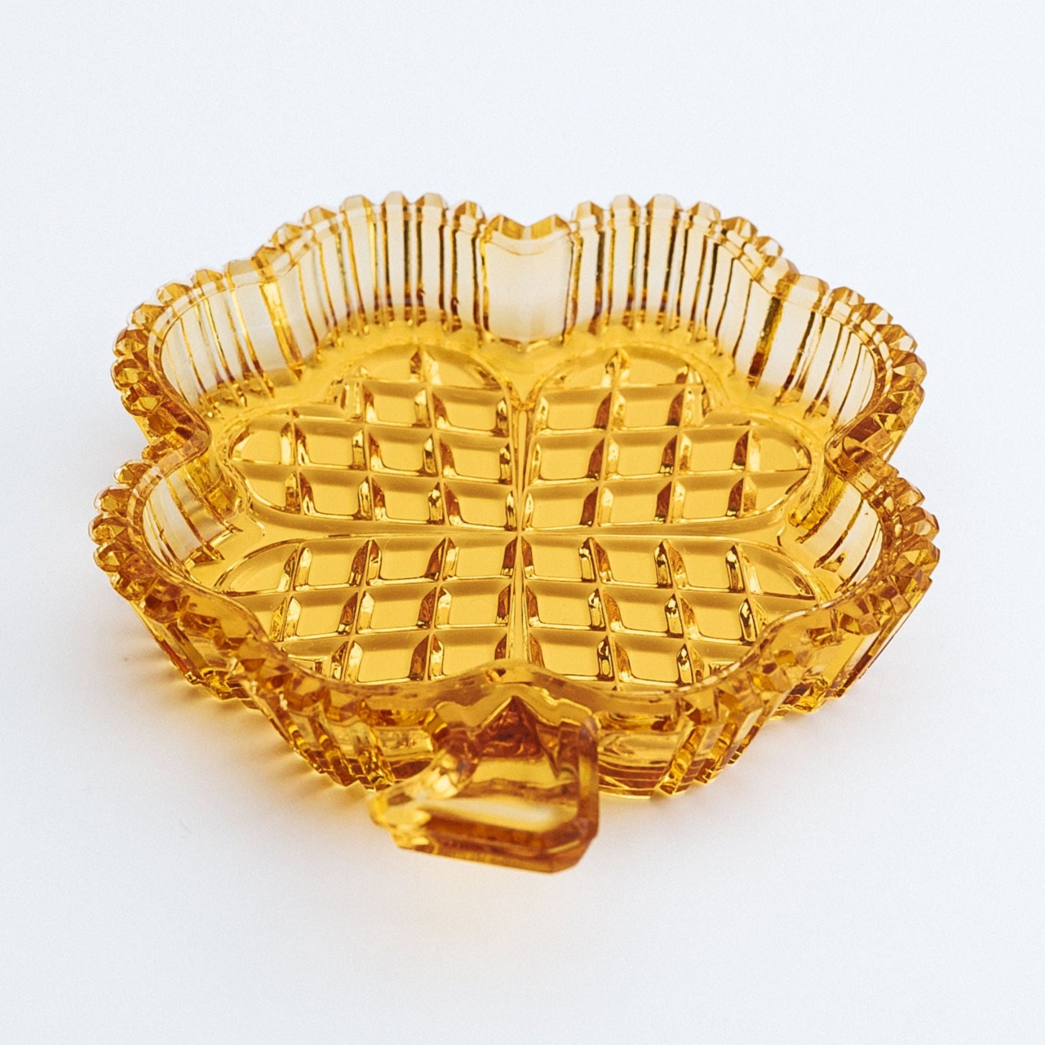 Orange glass dish with textured surface on a white background