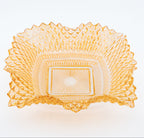 Decorative glass bowl with intricate patterns on a white background