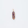 Gold purple gemstone pendant on a white background