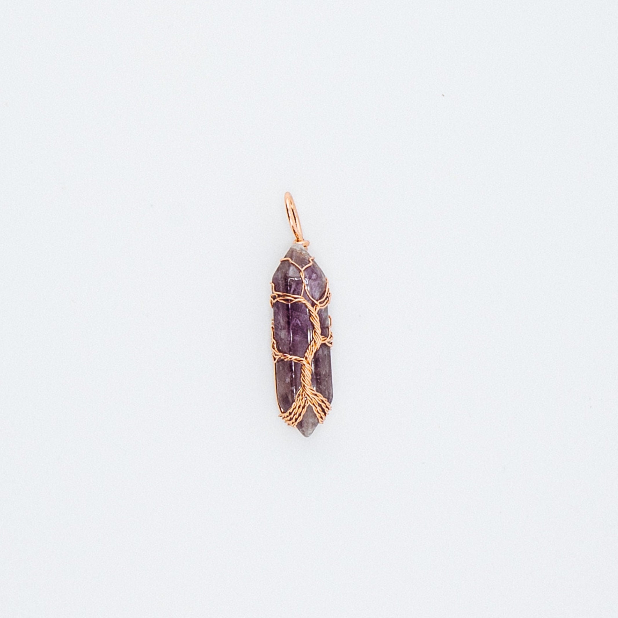Gold purple gemstone pendant on a white background