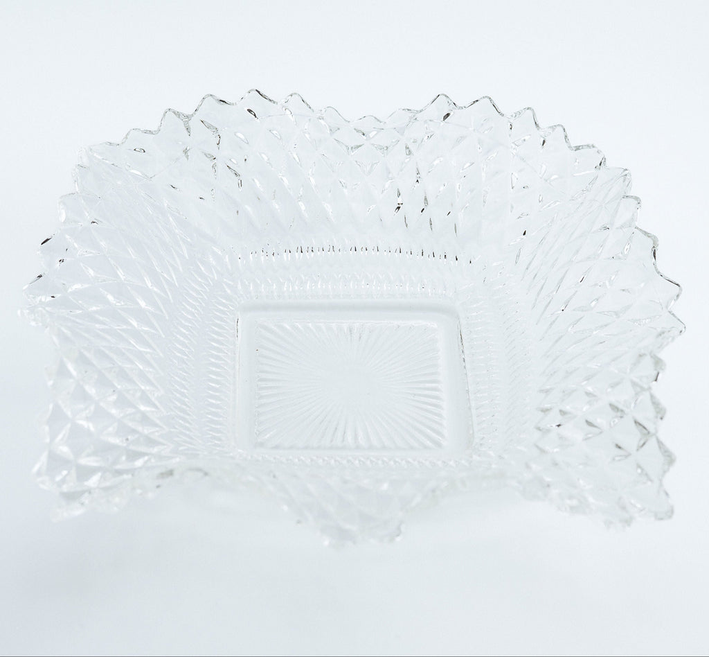 Clear glass plate with decorative edge on a white background