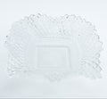 Clear glass plate with decorative edge on a white background