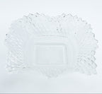 Clear glass plate with decorative edge on a white background
