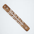 Wood piece with flower design on a white background